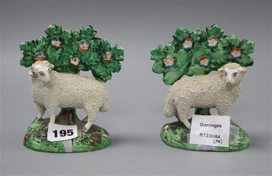 A pair of Staffordshire pottery models of sheep with bocage tallest 13cm